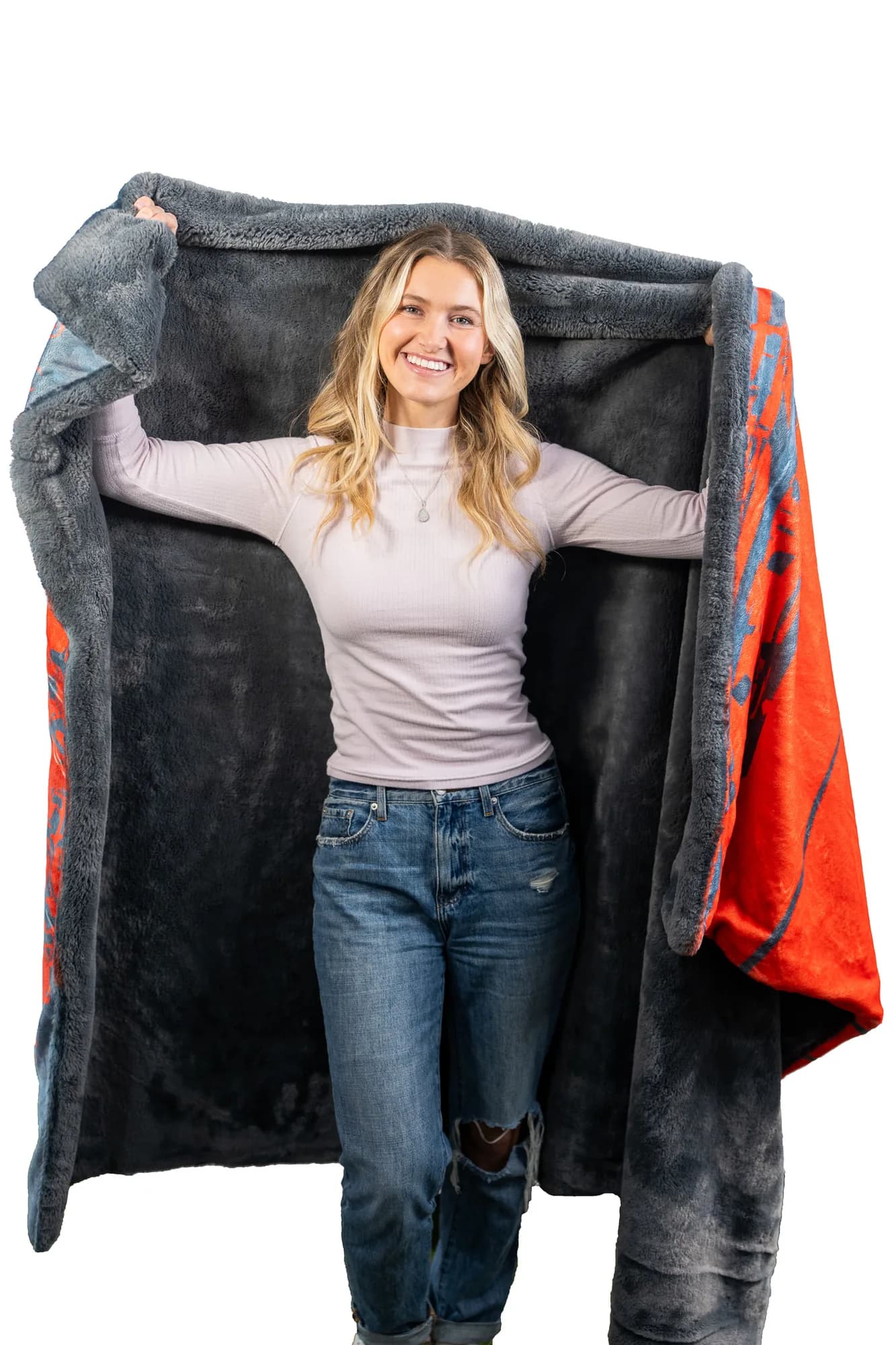 A child wrapped in a heavy plush Swanky keepsake school blanket